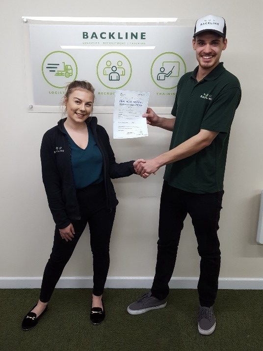 jamie makin holding his pass certificate with bridgwater branch manager amy manson.