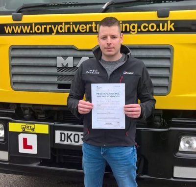 Dean holding his HGV test pass certificate